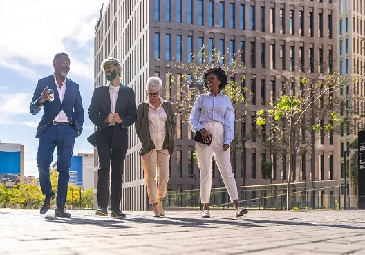 Multiracial group of business people walking along Multiracial group of business people walking along